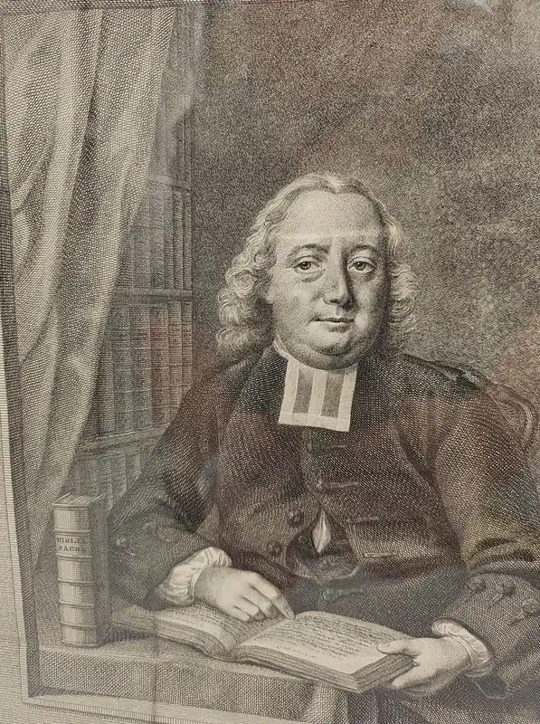 Shop Nu PORTRET. Jakob Gerard Staringh op 54-jarige leeftijd gekleed in preekjas met platte bef, zittend aan tafel met opengeslagen Bijbel. Door S. Troost Graveur: Reinier Vinkelis, 1771. Eronder een zesregelig Nederlands lofgedicht door H. Houtam. - Staringh, Jacob Gerard